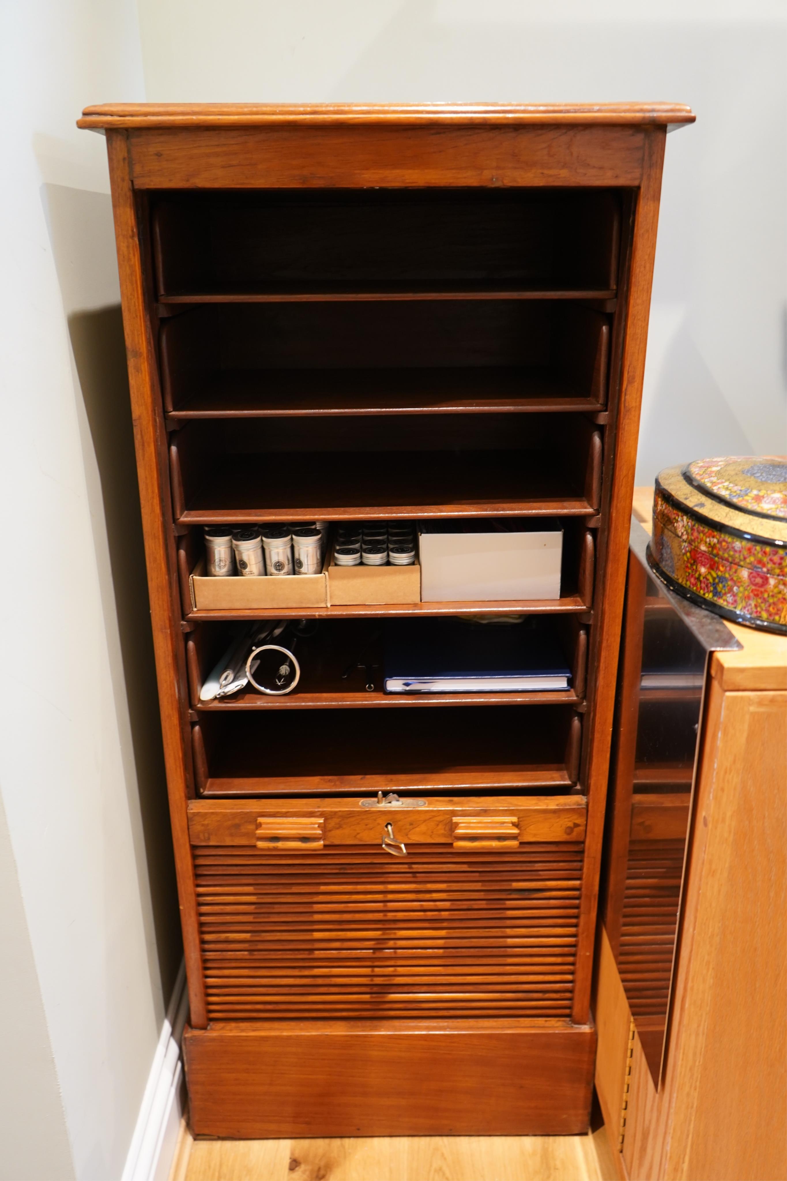 A 20th century Anglo Indian teak tambour filing cabinet, with lift up top and drawers, width 53cm, depth 42cm, height 121cm. Condition - good